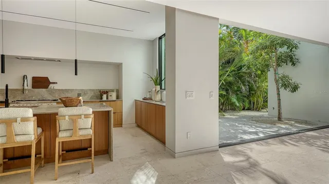 a living room with furniture and a floor to ceiling window