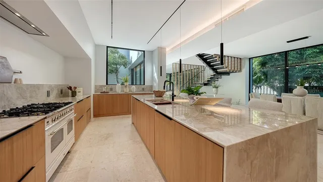 a view of a dining room with furniture a chandelier and wooden floor