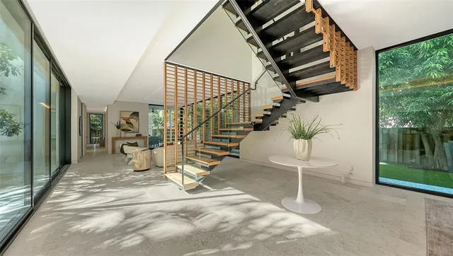 a living room with furniture and a floor to ceiling window