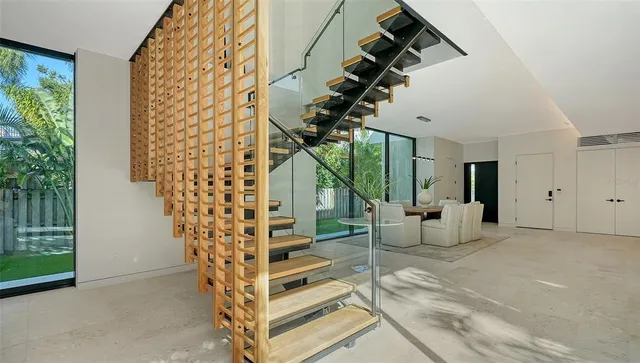 a living room with furniture and a floor to ceiling window