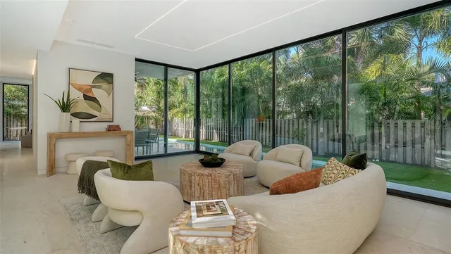 a living room with furniture and a floor to ceiling window