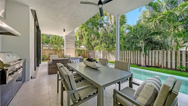 a living room with patio furniture and a garden