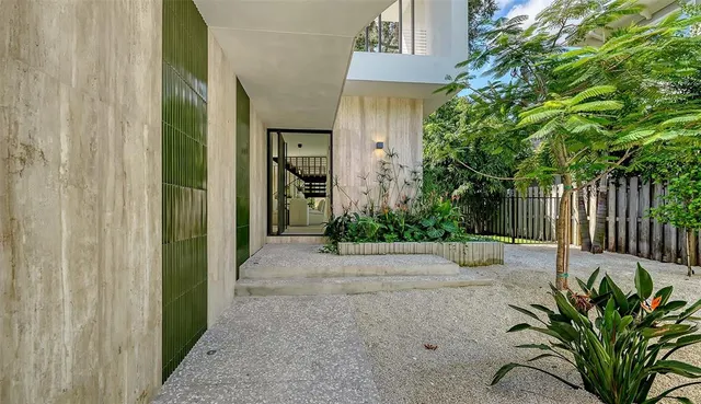 a kitchen with a table chairs refrigerator and cabinets