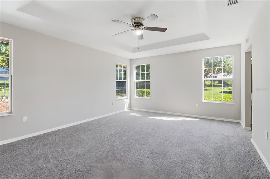 8105 Southwest 109th Street Ocala, FL 34481 - Photo 14 of 30 an empty room with windows and ceiling fan