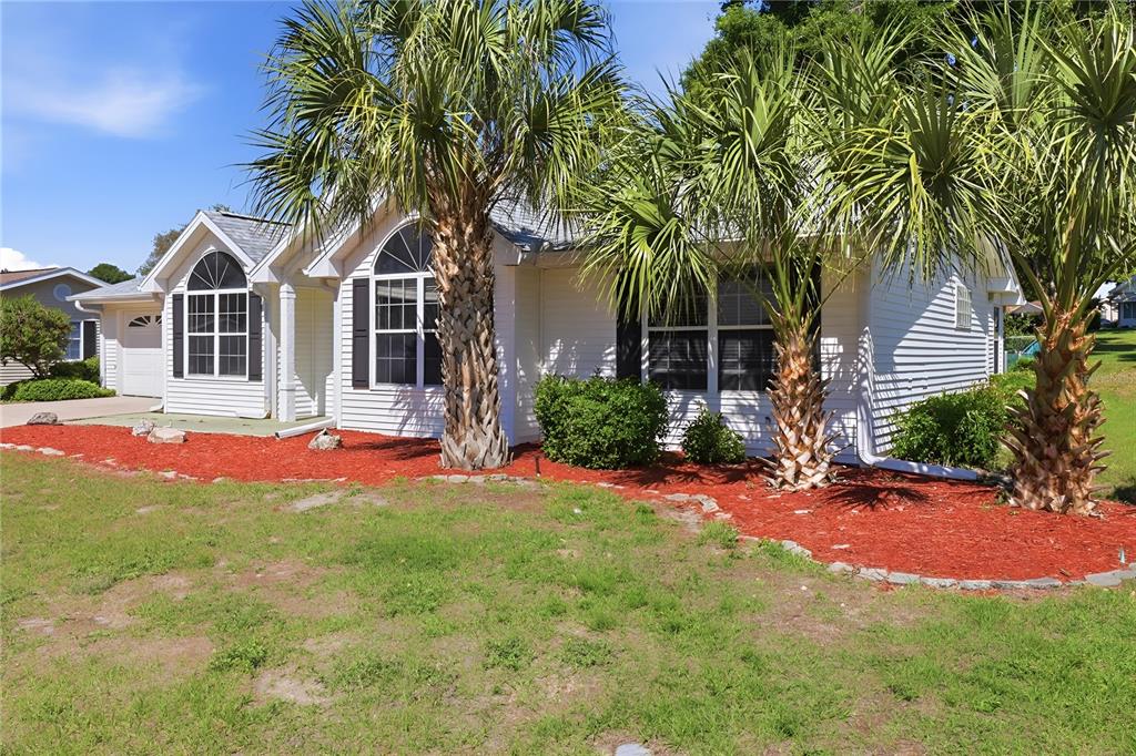 8105 Southwest 109th Street Ocala, FL 34481 - Photo 25 of 30 a front view of a house with yard and green space