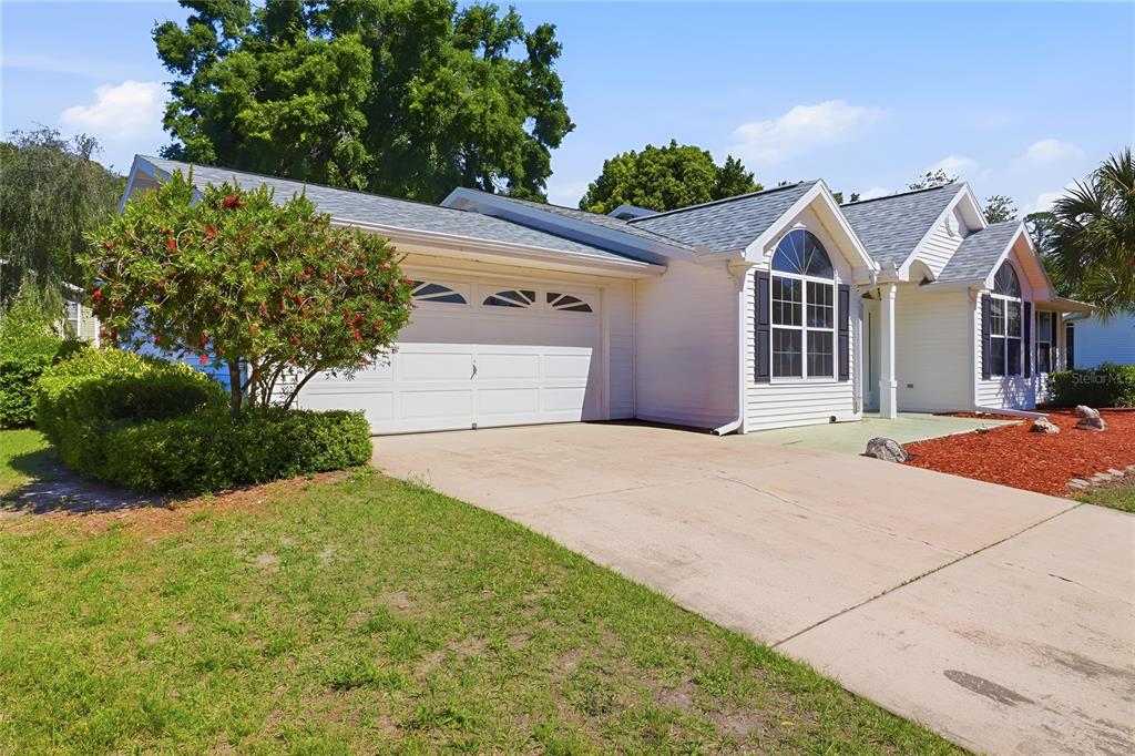 8105 Southwest 109th Street Ocala, FL 34481 - Photo 26 of 30 a front view of a house with a yard and garage
