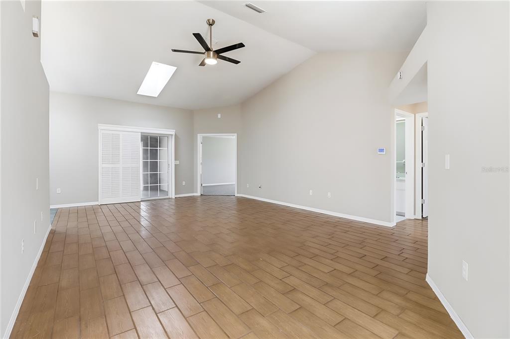 8105 Southwest 109th Street Ocala, FL 34481 - Photo 3 of 30 an empty room with wooden floor and windows