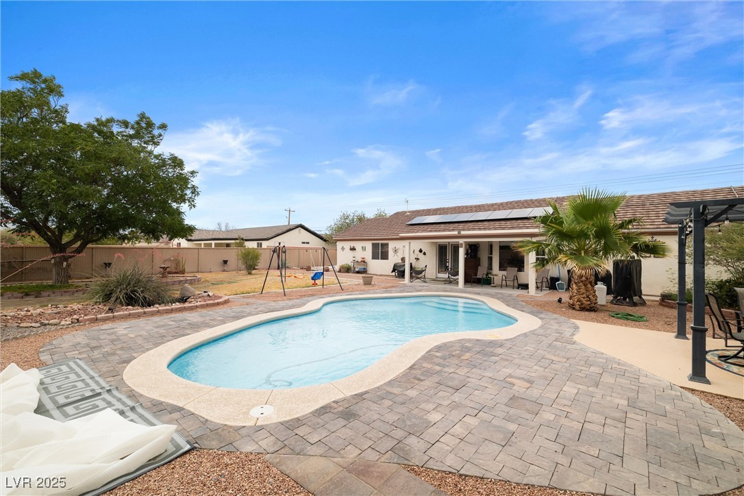 180 West Wilson Road Pahrump, NV 89048 - Photo 3 of 33 View of swimming pool featuring a patio area and a fenced backyard