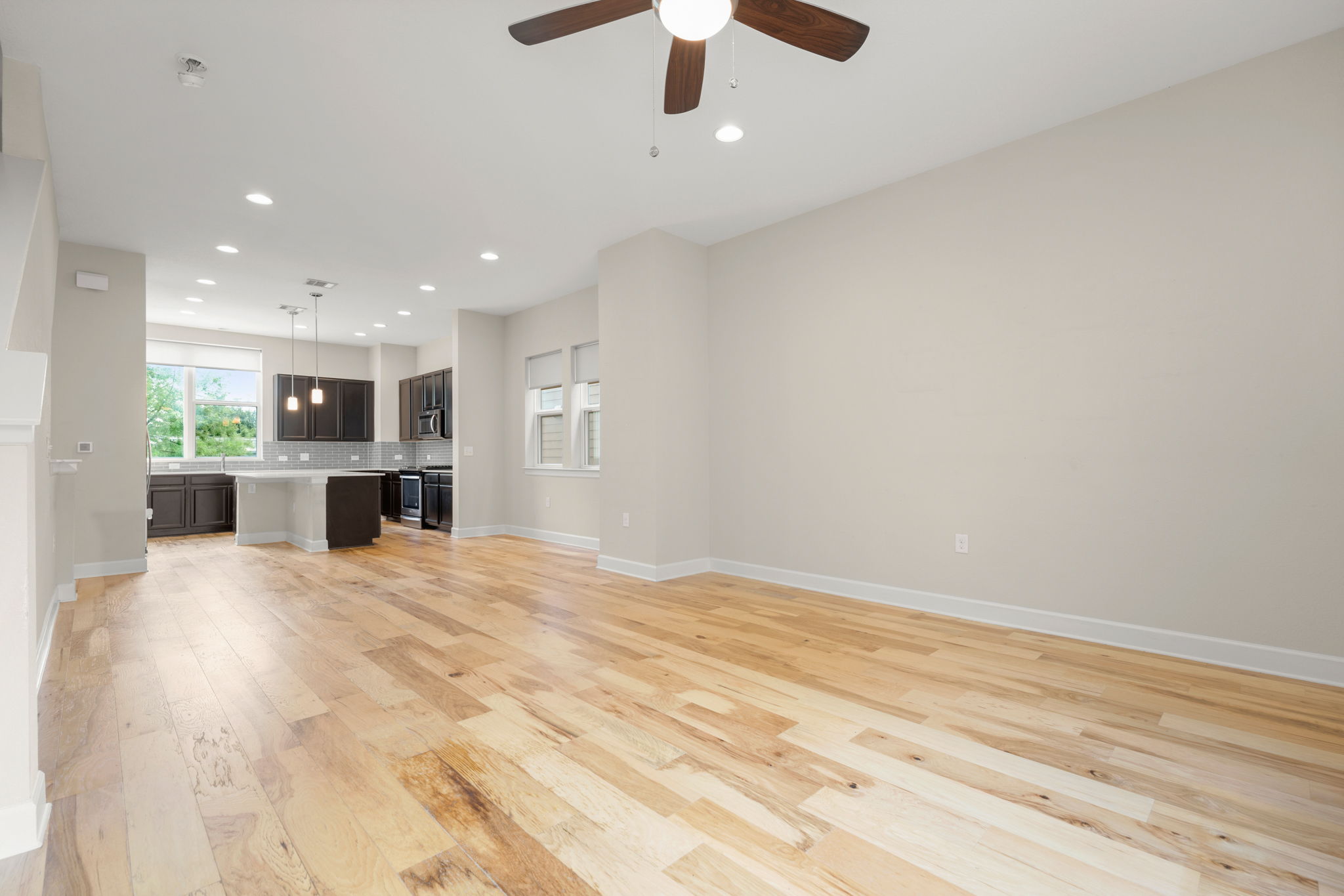 4403 Swift Path Austin, TX 78741 - Photo 9 of 32 Expansive open-concept living area featuring light wood flooring, recessed lighting, and a ceiling fan