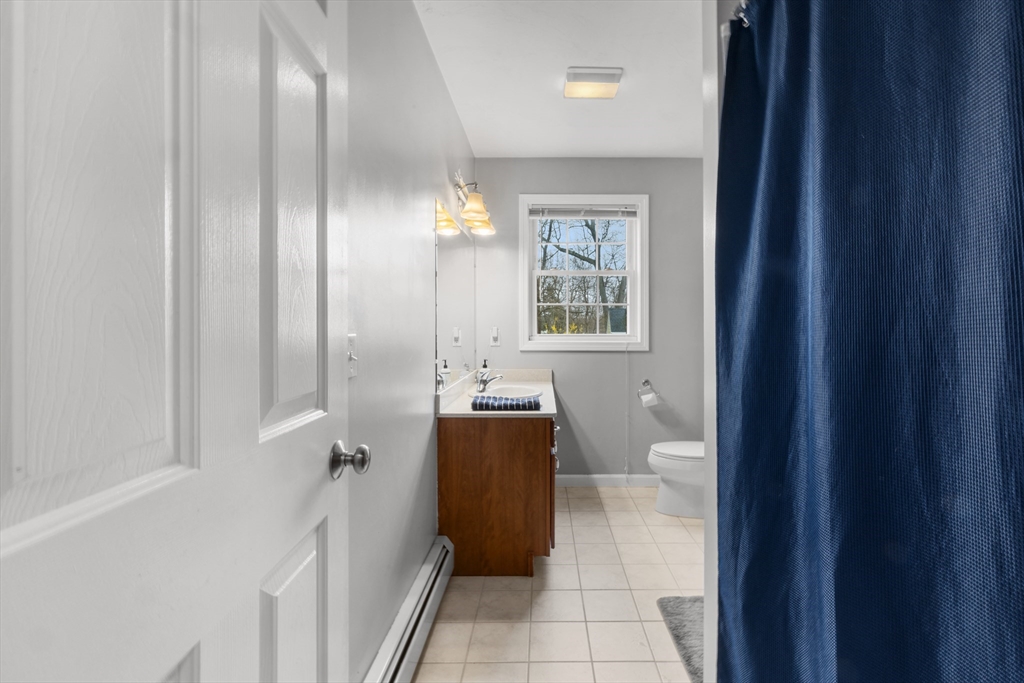 12 Pinckney Street, Unit A Taunton, MA 02780 - Photo 18 of 42 a bathroom with a granite countertop sink a toilet and shower