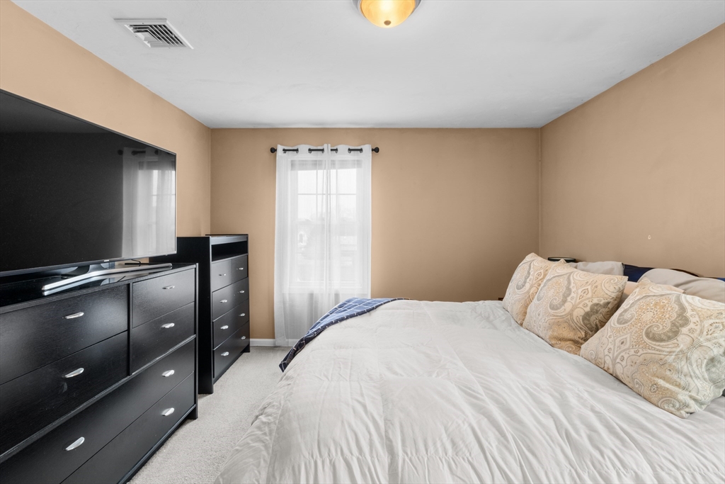 12 Pinckney Street, Unit A Taunton, MA 02780 - Photo 22 of 42 a bedroom with a bed and a flat screen tv