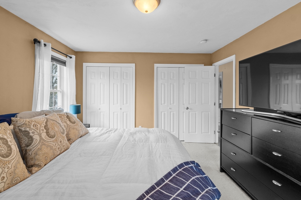 12 Pinckney Street, Unit A Taunton, MA 02780 - Photo 23 of 42 a bedroom with a bed and cabinets