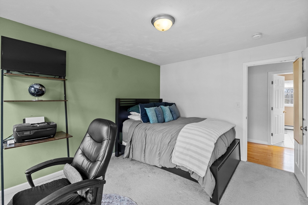 12 Pinckney Street, Unit A Taunton, MA 02780 - Photo 28 of 42 a bedroom with a bed and a flat screen tv