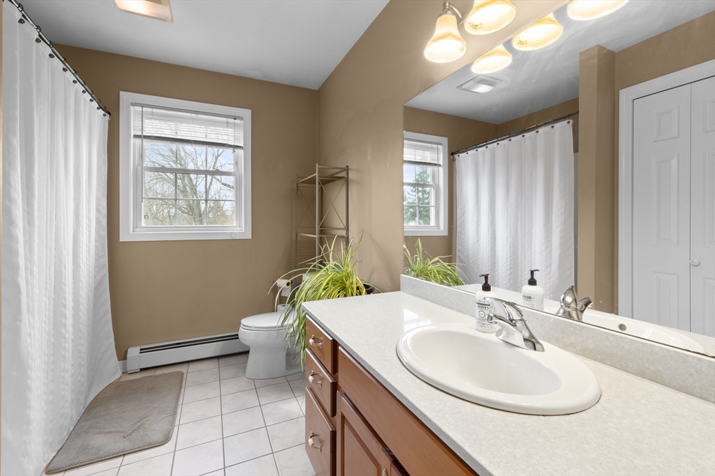 12 Pinckney Street, Unit A Taunton, MA 02780 - Photo 30 of 42 a bathroom with a double vanity sink toilet and a mirror