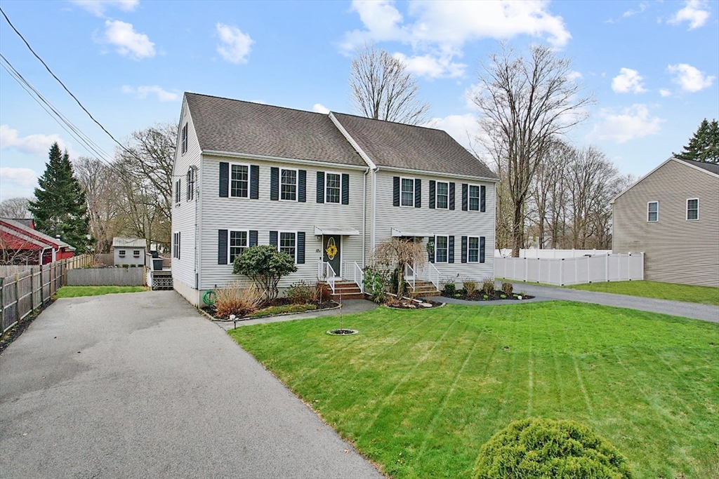 12 Pinckney Street, Unit A Taunton, MA 02780 - Photo 42 of 42 a front view of a house with a garden and trees