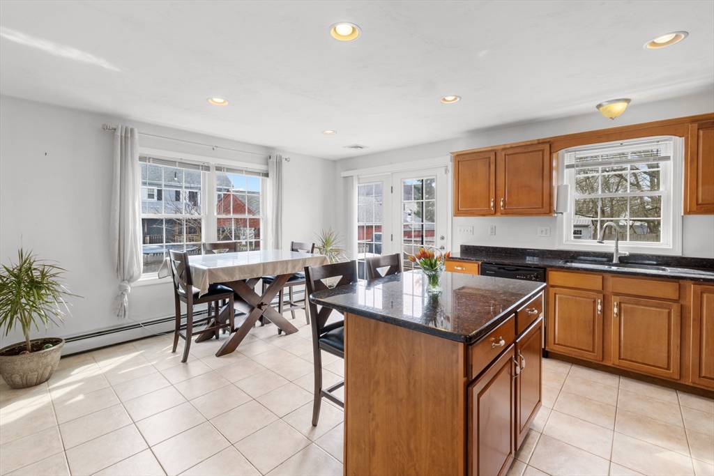 12 Pinckney Street, Unit A Taunton, MA 02780 - Photo 8 of 42 a kitchen with sink cabinets and dining table