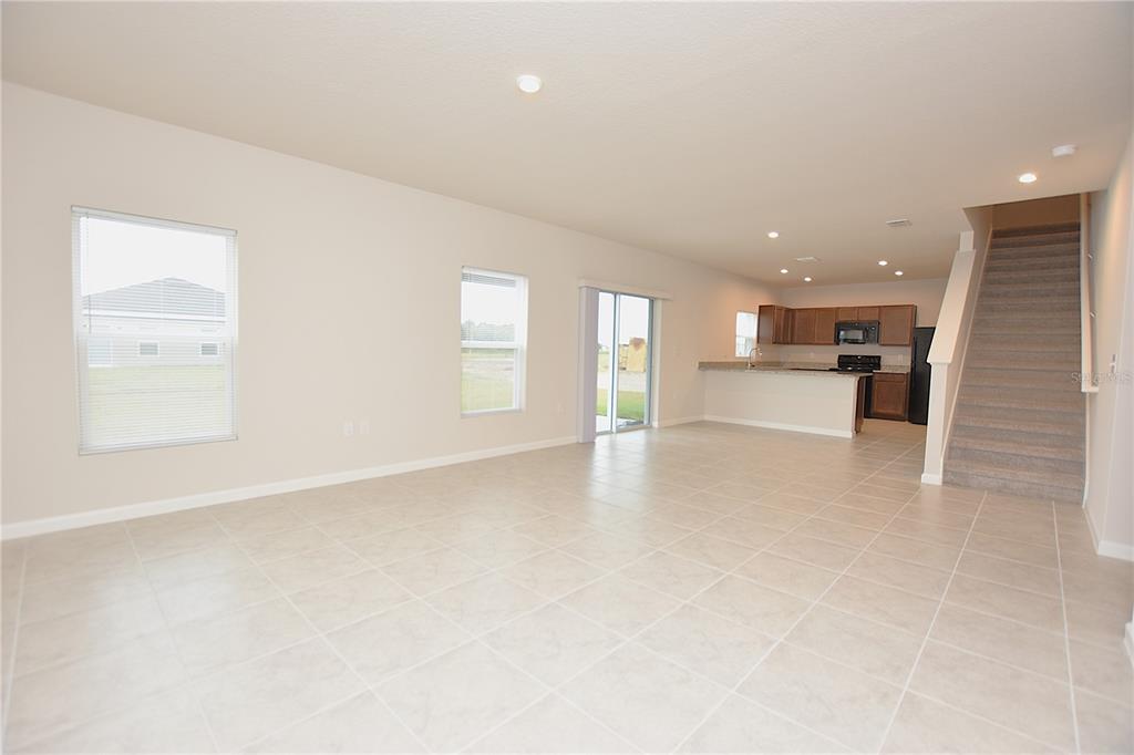622 Manchester Path Dundee, FL 33838 - Photo 11 of 46 an empty room with a kitchen and windows