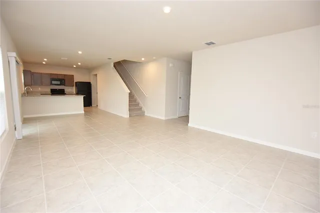 a view of a kitchen with a sink and a living room view