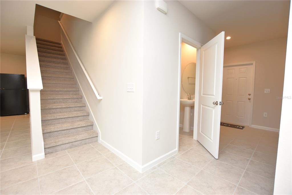 622 Manchester Path Dundee, FL 33838 - Photo 13 of 46 a view of a hallway with stairs and a room