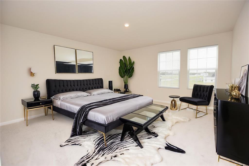 622 Manchester Path Dundee, FL 33838 - Photo 21 of 46 a bedroom with a bed and wooden floor