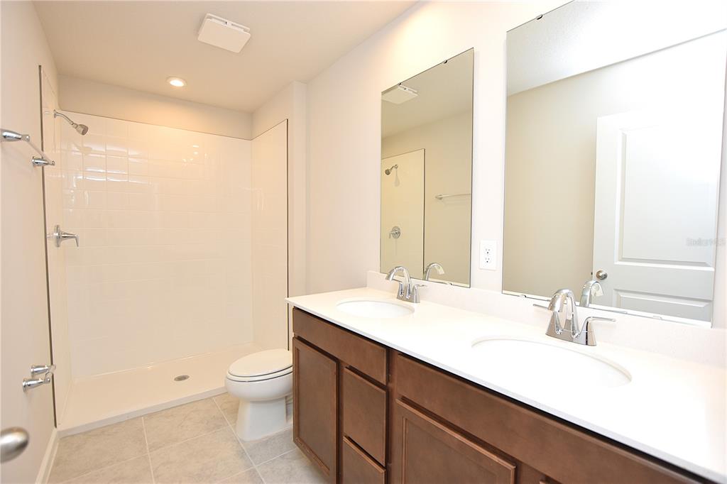 622 Manchester Path Dundee, FL 33838 - Photo 24 of 46 a bathroom with a sink a toilet and shower