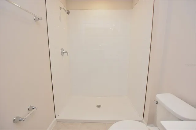 a bathroom with a toilet and shower