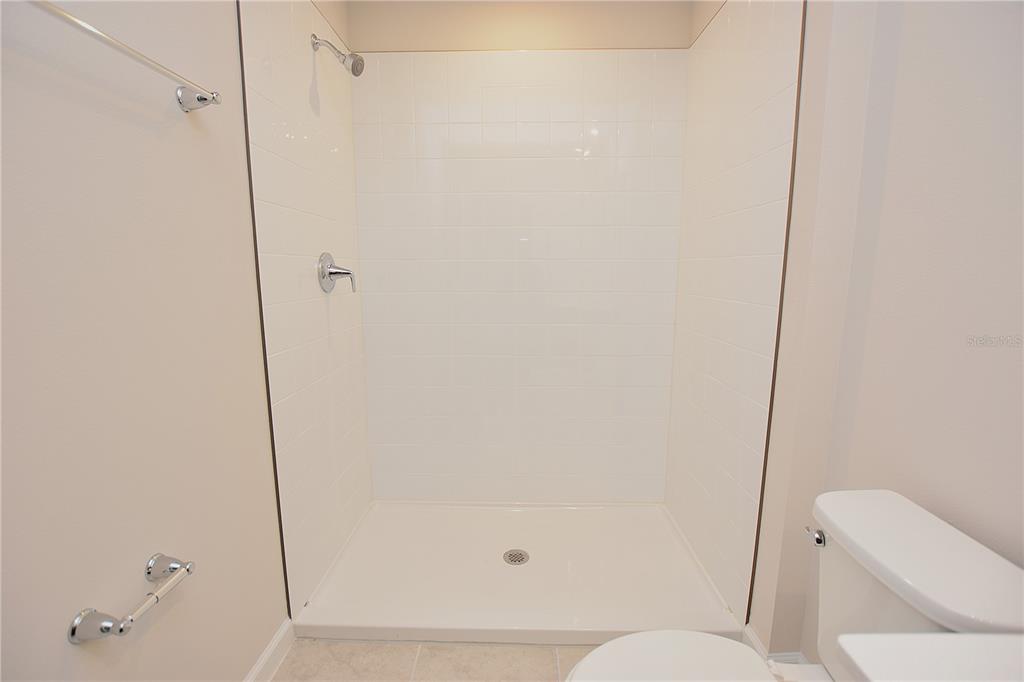 622 Manchester Path Dundee, FL 33838 - Photo 25 of 46 a bathroom with a toilet and shower