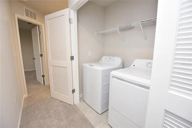 a view of storage and utility room with washer and dryer