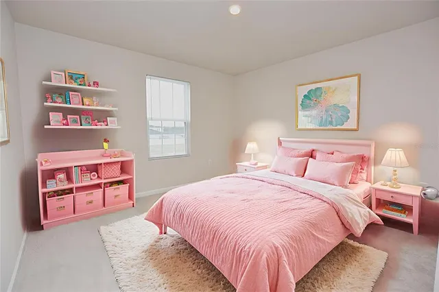 a bedroom with a bed and painting on the wall