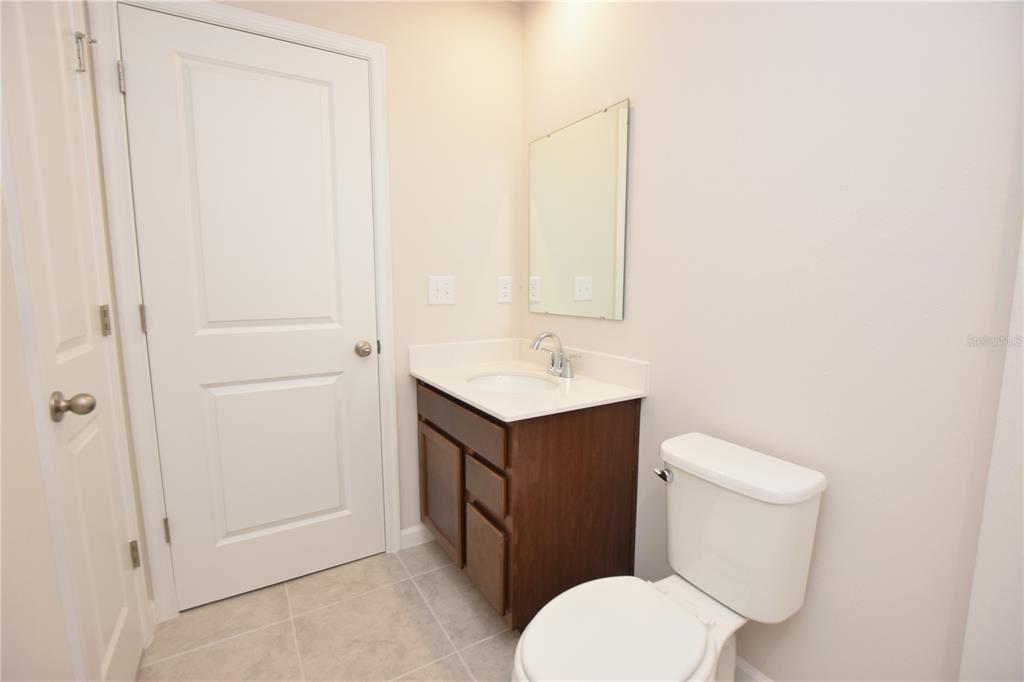 622 Manchester Path Dundee, FL 33838 - Photo 33 of 46 a bathroom with a toilet sink and mirror