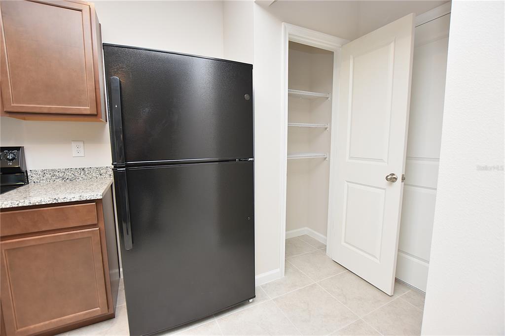 622 Manchester Path Dundee, FL 33838 - Photo 4 of 46 a view of a refrigerator in kitchen and stainless steel appliances wooden floor