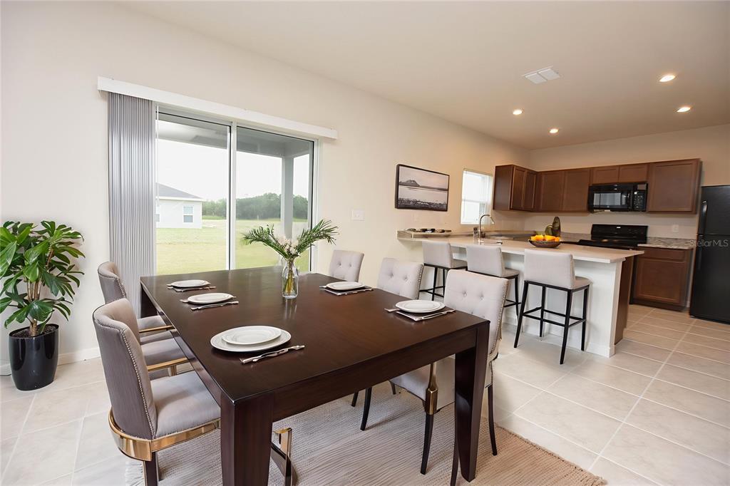 622 Manchester Path Dundee, FL 33838 - Photo 7 of 46 a view of a dining room with furniture
