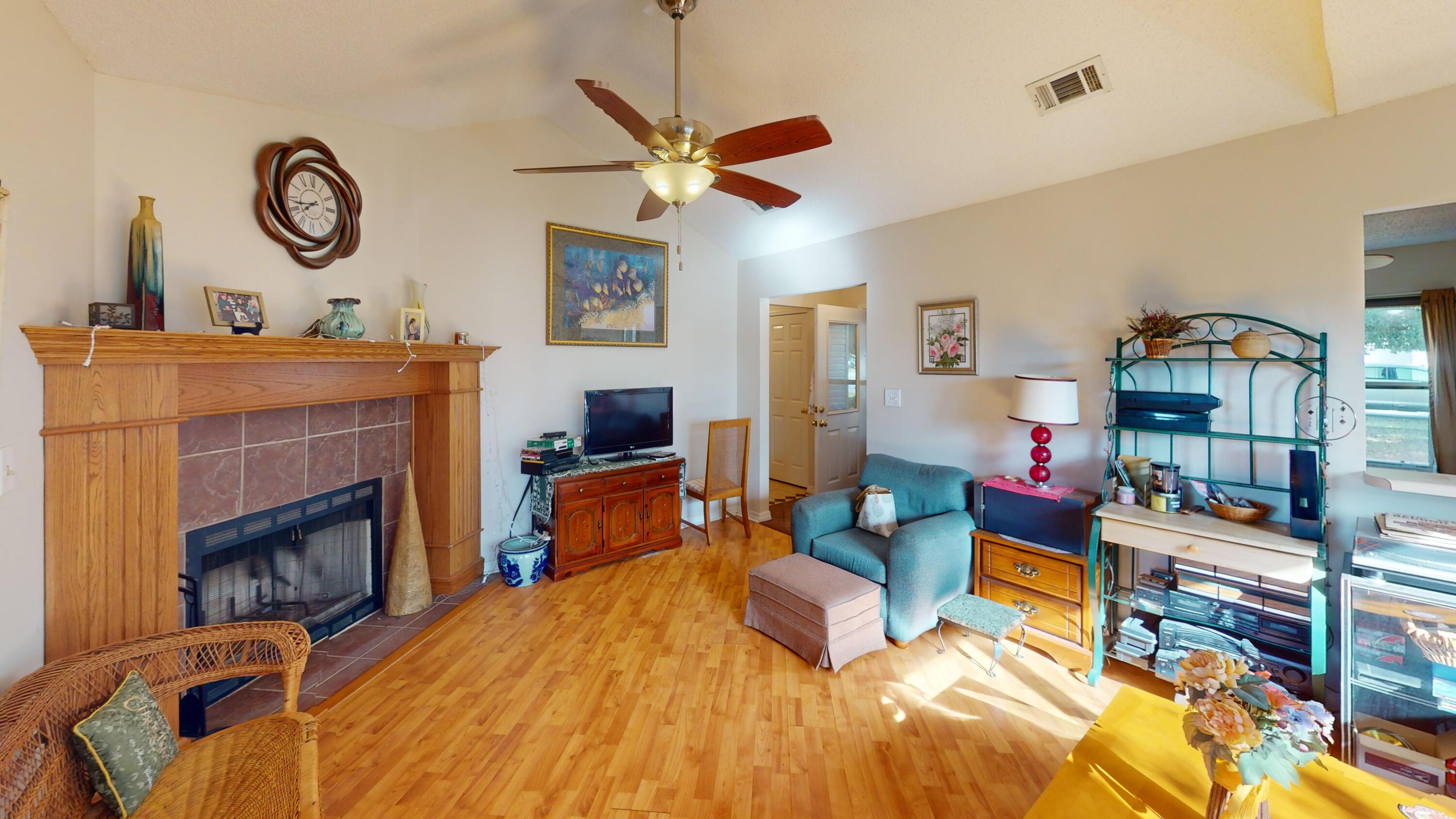 2293 Estate Circle Navarre, FL 32566 - Photo 12 of 41 a living room with furniture a fireplace and a large window