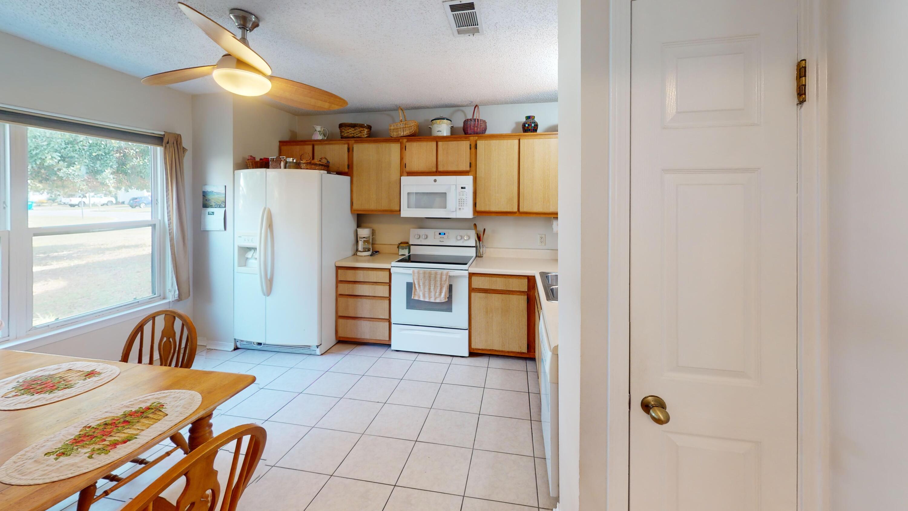 2293 Estate Circle Navarre, FL 32566 - Photo 14 of 41 a kitchen with stainless steel appliances a refrigerator and a stove