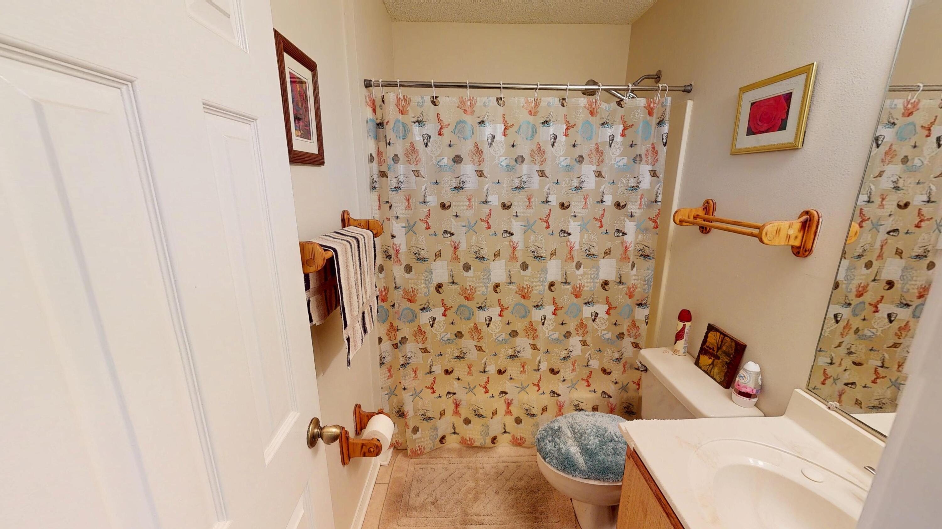 2293 Estate Circle Navarre, FL 32566 - Photo 23 of 41 a bathroom with a toilet and a shower curtain