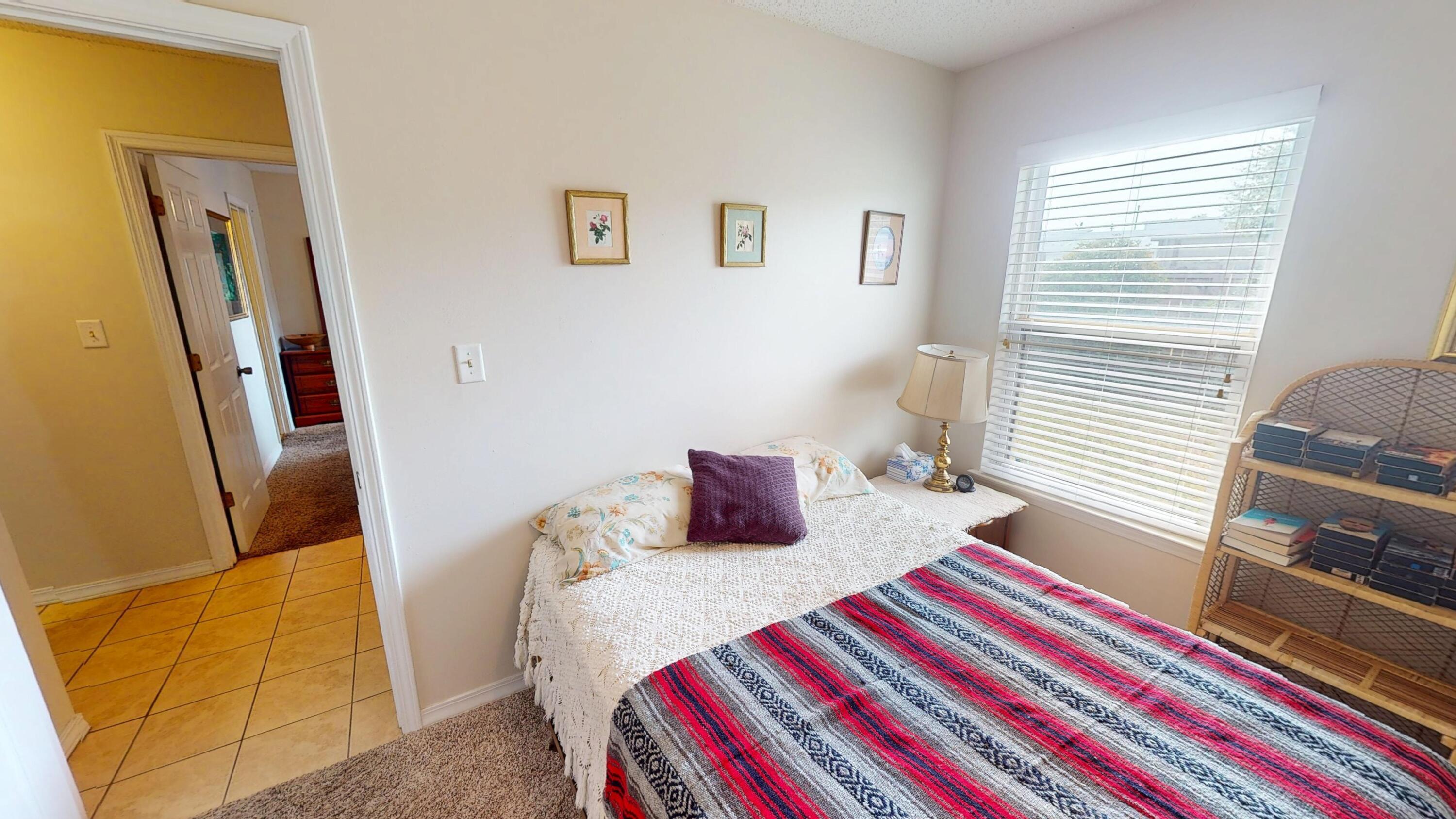 2293 Estate Circle Navarre, FL 32566 - Photo 26 of 41 a bedroom with a bed and wooden floor