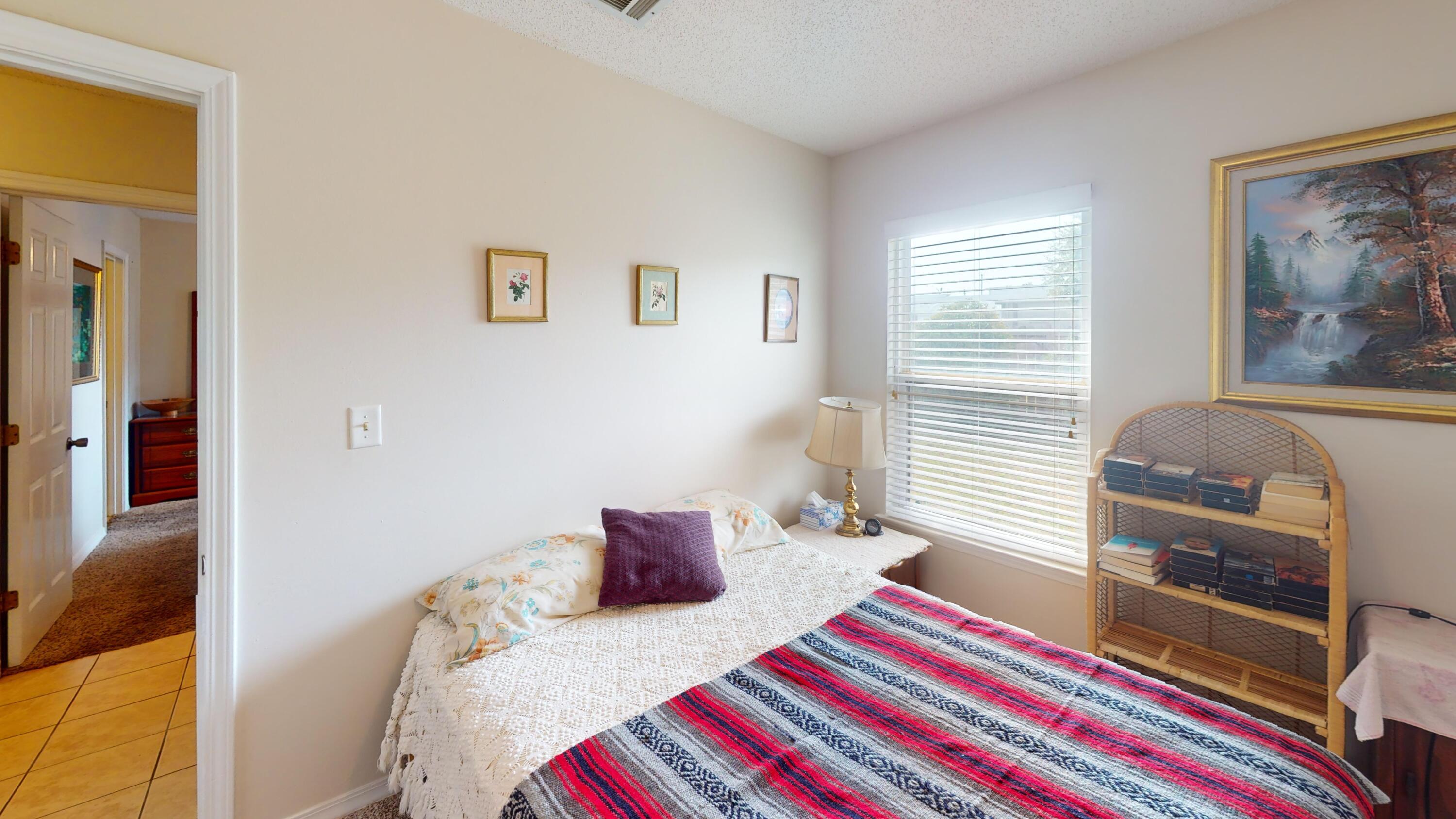 2293 Estate Circle Navarre, FL 32566 - Photo 28 of 41 a bedroom with a bed and a lamp on dresser