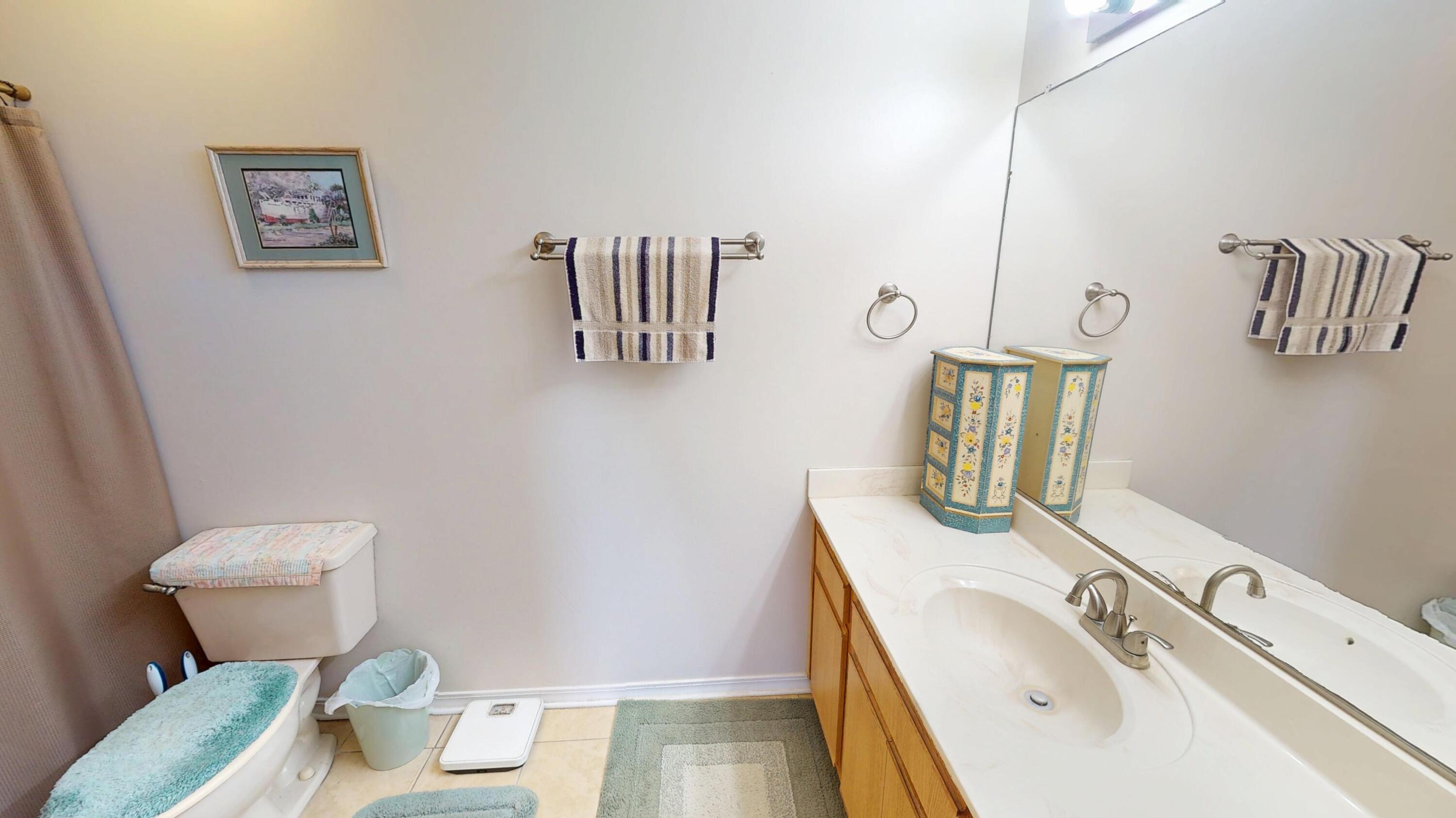 2293 Estate Circle Navarre, FL 32566 - Photo 30 of 41 a bathroom with a toilet sink and mirror