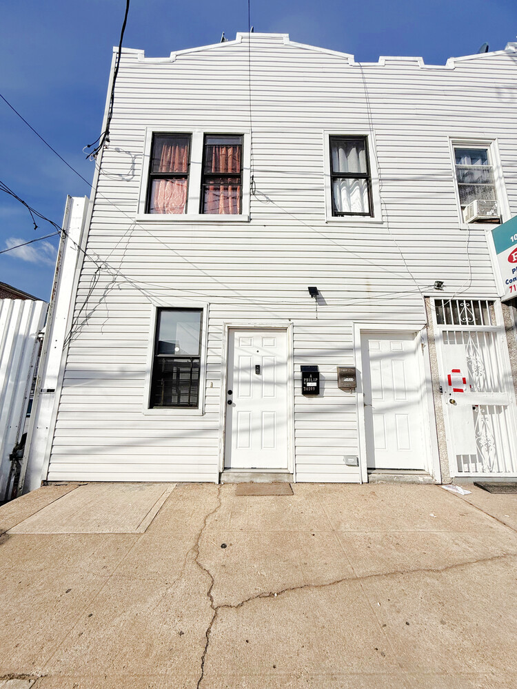 10209 Glenwood Road Brooklyn, NY 11236 - Photo 2 of 7 a view of a house with a garage