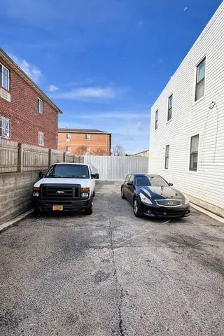 a couple of cars parked in front of a building