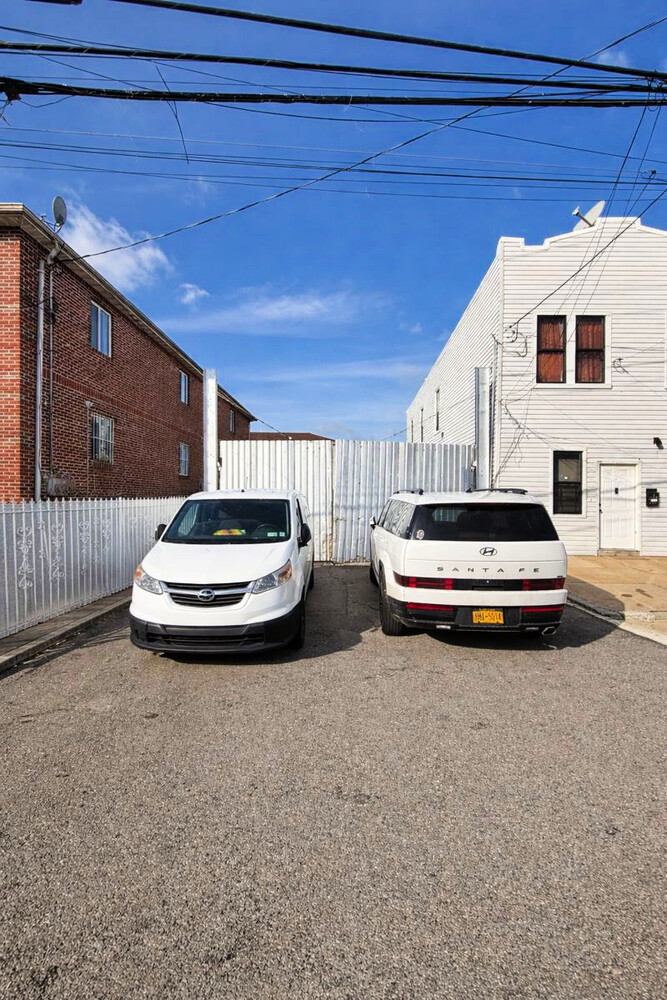 10209 Glenwood Road Brooklyn, NY 11236 - Photo 5 of 7 a car parked in front of house