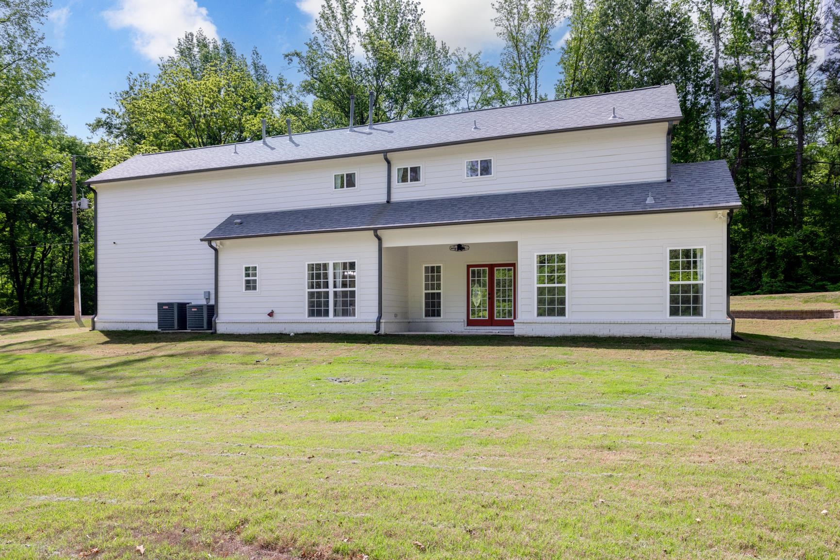 5702 Spring Lake Road Memphis, TN 38135 - Photo 38 of 40 Rear elevation featuring white horizontal siding, a covered patio area, and red double doors