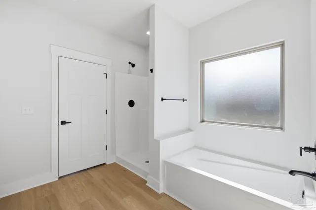 a view of bathroom with bathtub and shower