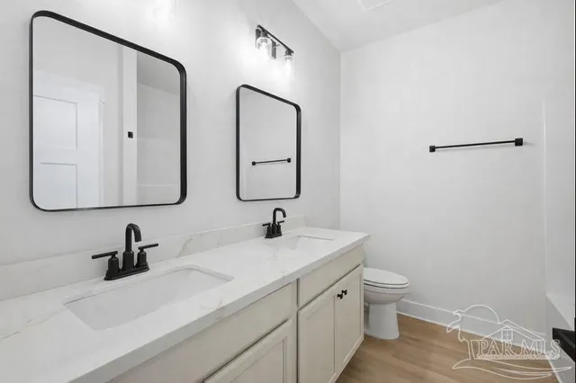 a bathroom with 2 sink and a mirror