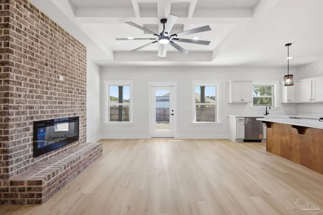 a view of an empty room with a fireplace and a window