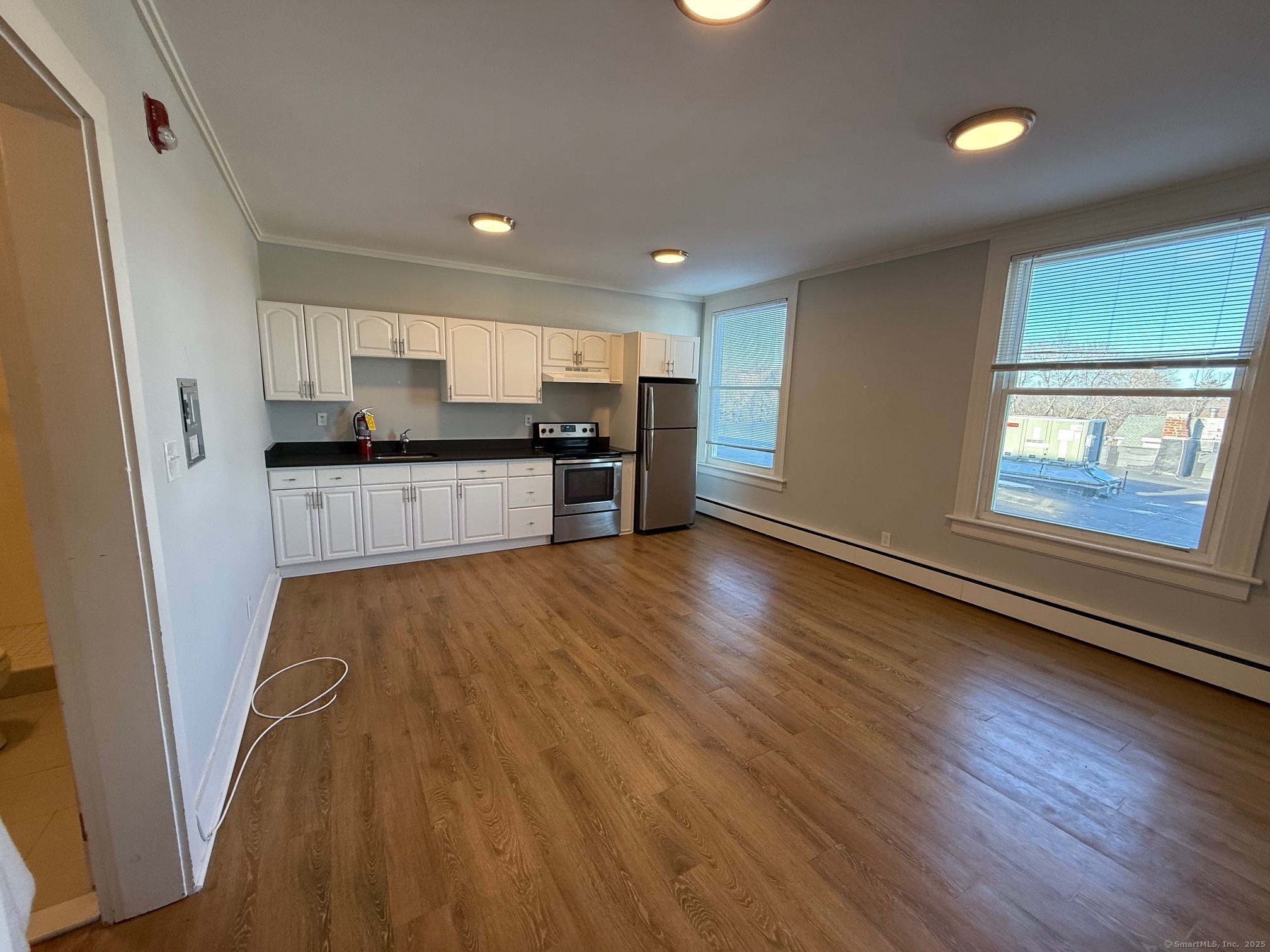 406 Main Street, Unit 4 Ridgefield, CT 06877 - Photo 1 of 1 a large kitchen with a wooden floor and stainless steel appliances