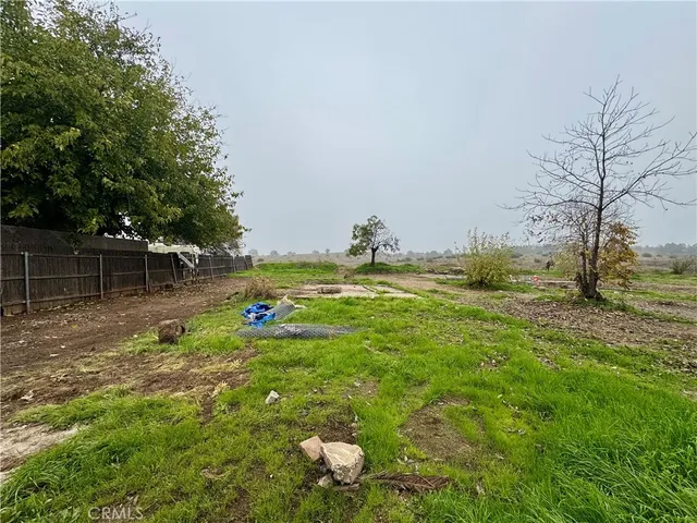 a view of yard with swimming pool and seating space