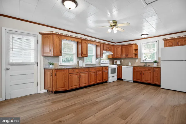 a kitchen with a sink cabinets and window