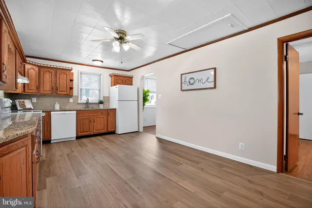 a view of a kitchen with a sink cabinets and wooden floor