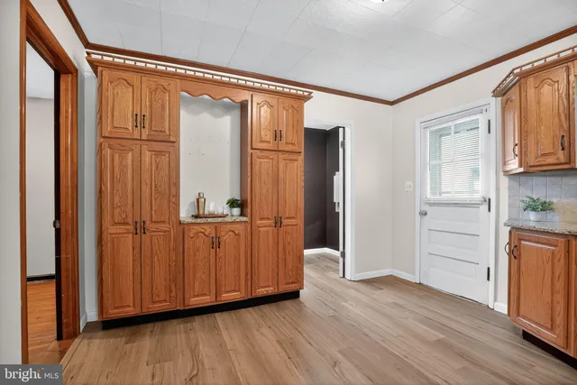 a view of walk in closet with wooden floor